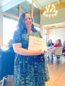 Photo of Graduate Student of the Year Award Winner, Hillary Anderson, holding certificate and smiling