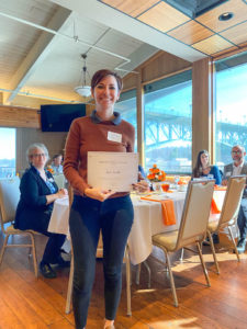 Photo of Graduate Student of the Year Award Winner, Jess Croll, holding certificate and smiling.