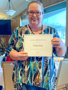 Photo of Graduate Student of the Year Award Winner, Ashley King, holding certificate and smiling. 