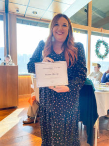 Photo of Graduate Student of the Year Award Winner, Kristen Massey, holding certificate and smiling.