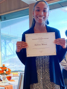 Photo of Graduate Student of the Year Award Winner, Chelsea Wilson, holding certificate and smiling.